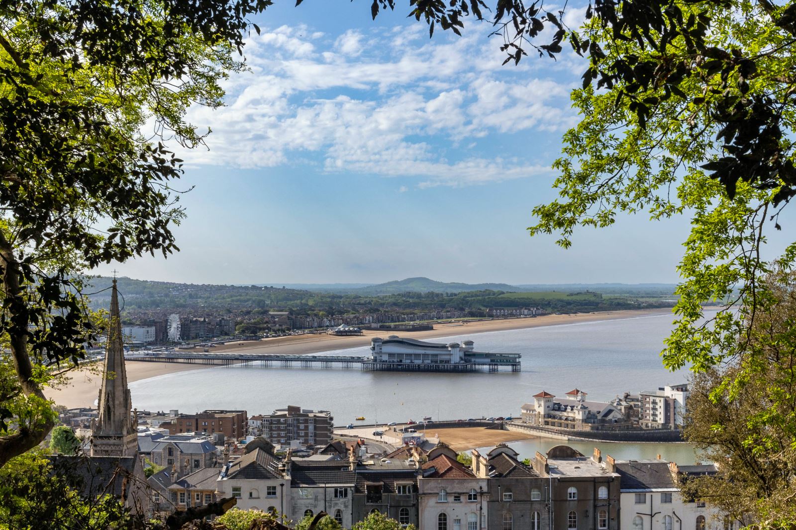 View through woods looking down on the seaside town of Weston-super-Mare